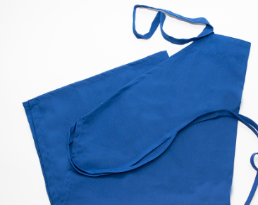 The Prisma Bib Apron by Calderon Textiles, made from MJS polyester with neck and waist straps, lies flat on a white surface, offering superior comfort.