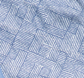 The Quilted With Snaps by Calderon Textiles features blue and white fabric with a geometric rectangle pattern for a woven basket look. Its soft, slightly wrinkled texture makes it ideal as a dignified adult bib or adjustable clothing protector.
