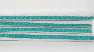 A stack of four Calderon Textiles Kitchen towels, white with teal edge stripes and a herringbone weave, are neatly folded and arranged horizontally against a plain white background.