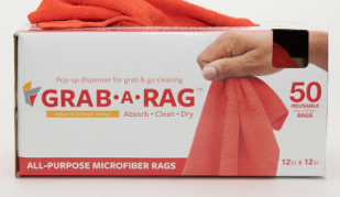 A hand pulls a bright orange Grab-A-Rag, General Purpose by Calderon Textiles from a white and red box containing 50 reusable, all-purpose microfiber rags (12 x 12 in)—ideal for any cleaning task.