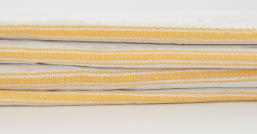 A stack of Calderon Textiles Kitchen towels, featuring a white herringbone weave with yellow stripes, are neatly folded against a plain background.