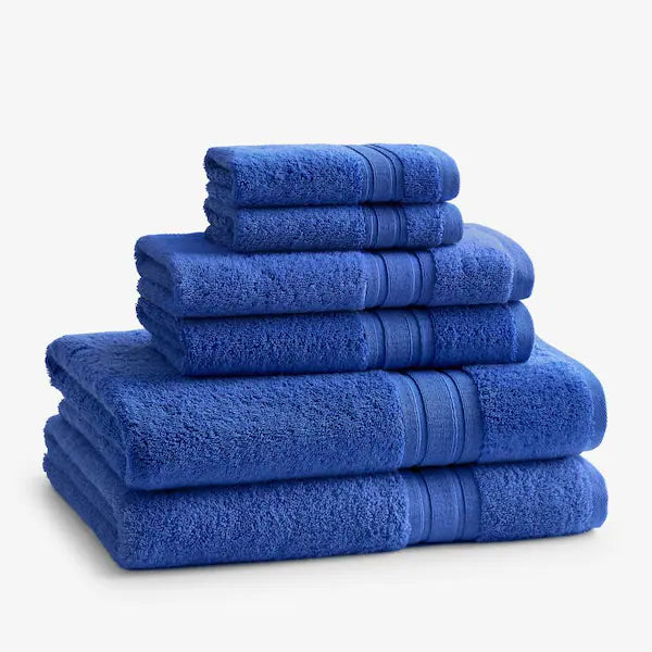 A neatly stacked set of Calderon Textiles International Wash Cloths, made from 100% cotton in blue, arranged pyramid-style against a plain white background.