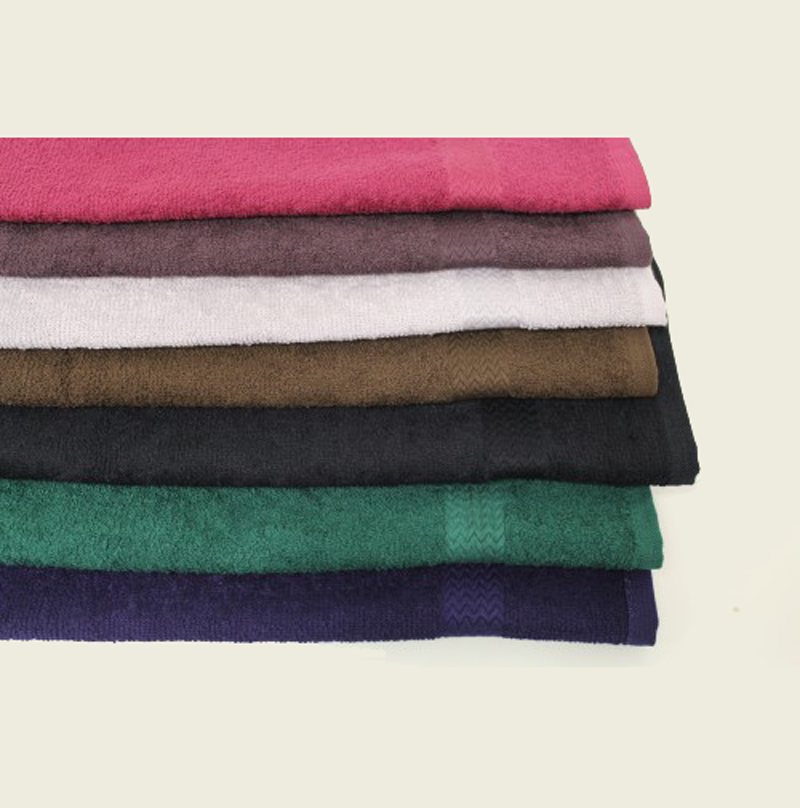 A stack of seven Intralin Spa Hand Towel - Prism Bleach Safe Premium Hand Towels in assorted colors—pink, brown, white, black, green, and dark blue—neatly folded on a light background; VAT dyed and bleach safe for lasting vibrancy.