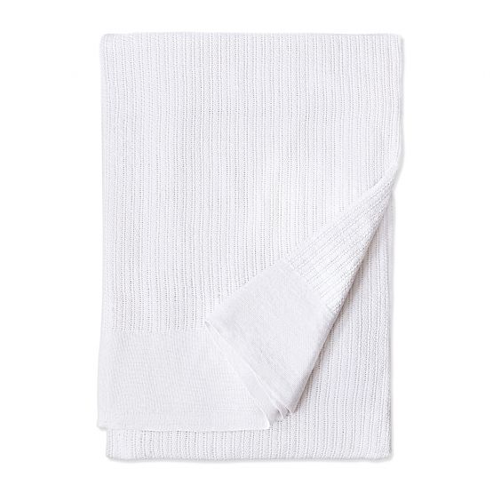 The Intralin Blankets - Leno Weave Blanket in white is shown folded on a plain background, with one corner turned up to showcase the snag-free, durable, and easy-care design.