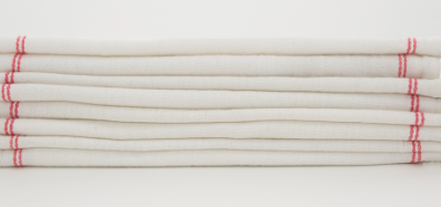 A neatly stacked pile of Calderon Textiles Kitchen towels, white with red-edged stripes and herringbone weave, placed against a plain white background.