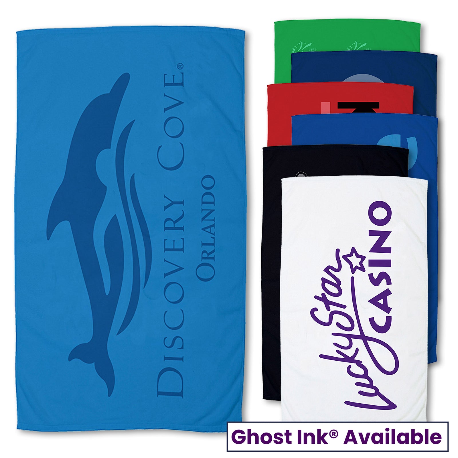 A blue Small Beach Towel by Pro Towels featuring a dolphin and Discovery Cove Orlando, displayed beside five stacked towels (green, red, black, navy, white). The white towel shows Lucky Star Casino. Text: Ghost Ink Available.