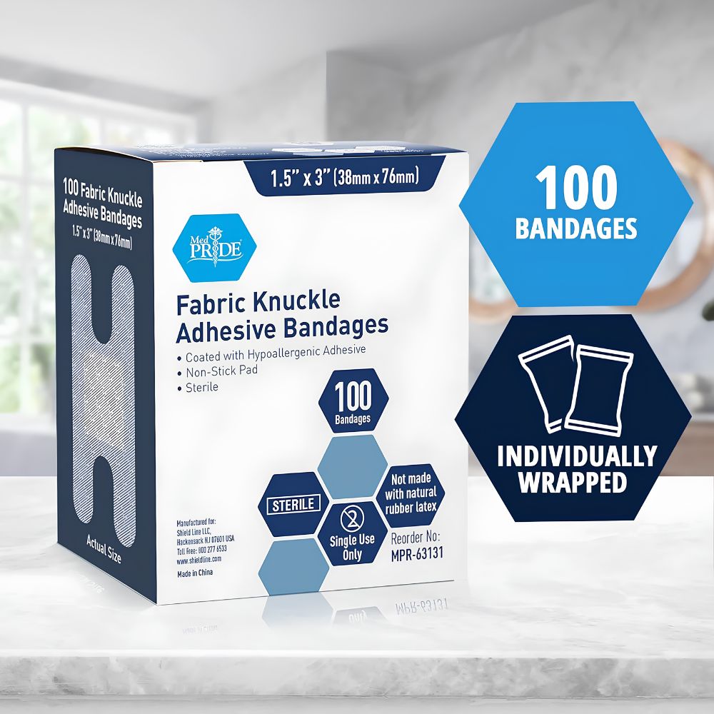 A box of Shield Line MedPride Sterile Fabric Knuckle Adhesive Bandages (1.5" x 3"), containing 100 individually wrapped, hypoallergenic, latex-free bandages with a non-stick pad, displayed on a countertop with product features shown.