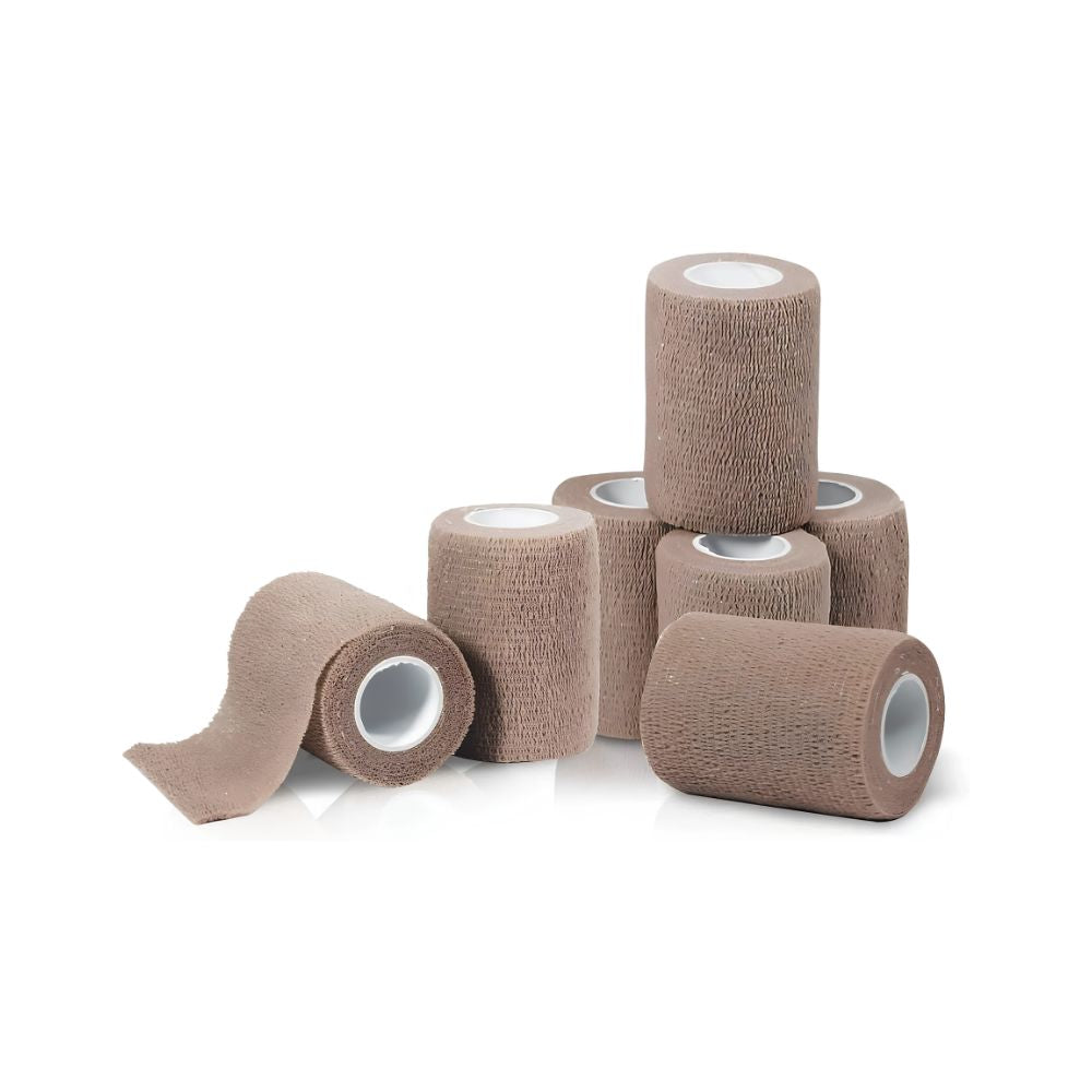 Sixteen rolls of Shield Line Medpride Self-Adherent Wrap first aid bandages in tan are displayed on a white background, with one roll partially unspooled at the front and the rest stacked or upright behind it.