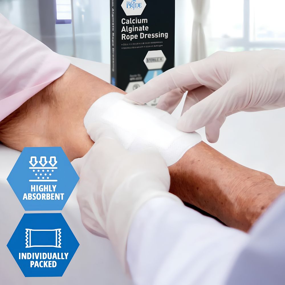 Wearing gloves, someone applies a white bandage to another’s arm. A box of Shield Line MedPride Calcium Alginate Rope Dressing (3/4"x12") is visible, showing icons for Highly Absorbent, Wound Packing, and Individually Packed.
