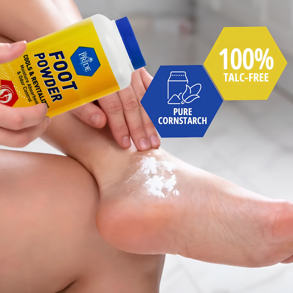 In a clean, tiled bathroom, a person applies Shield Line MedPride Cooling Foot Powder Talc Free Odor Absorber Shoe Deodorizer (6 oz) to their foot for moisture control. The yellow container is labeled 100% talc-free and pure cornstarch.