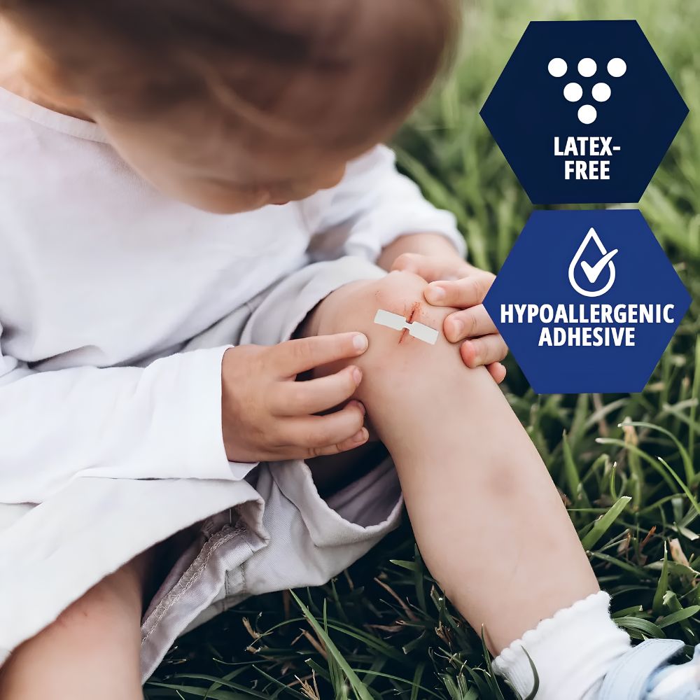 A child on grass applies a Shield Line MedPride Butterfly Wound Closure (Latex-Free, Hypoallergenic Adhesive) to their knee. Overlay graphics highlight the product's skin-friendly benefits.