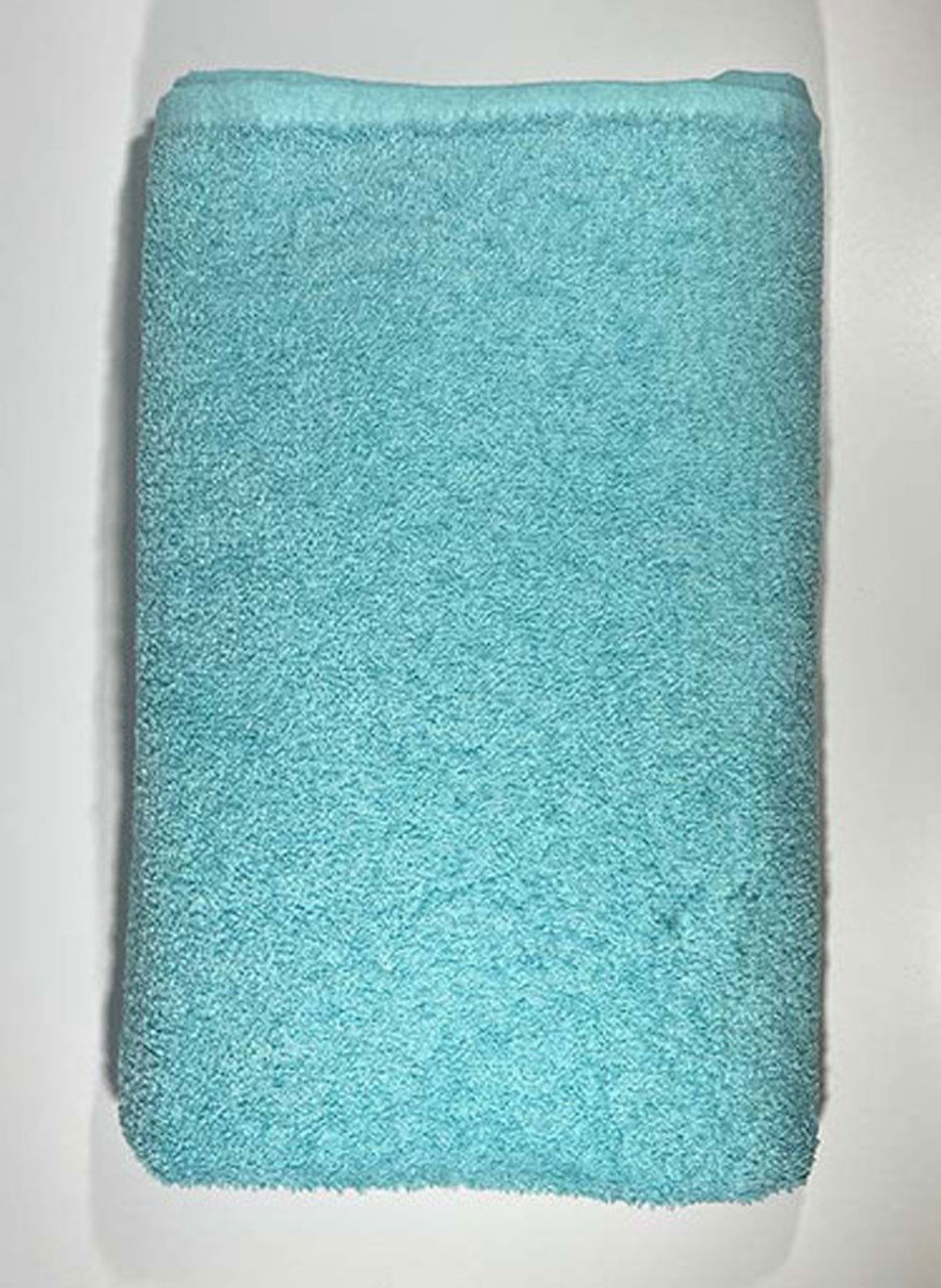 A neatly folded Oxford Solid Color Pool Towel (Bronze-Classic) by Ganesh Mills is placed on a white surface, viewed from above.