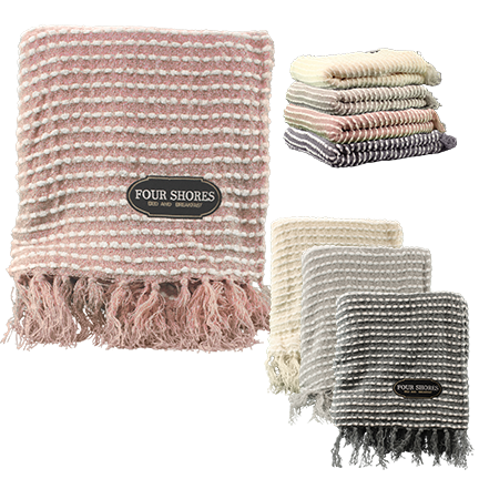 Textured towels in soft pastel shades—pink, cream, gray, and beige—with fringed edges and a Four Shores label by Pro Towels. Ideal for pairing with the Charleston Throw or personalizing with embroidery.