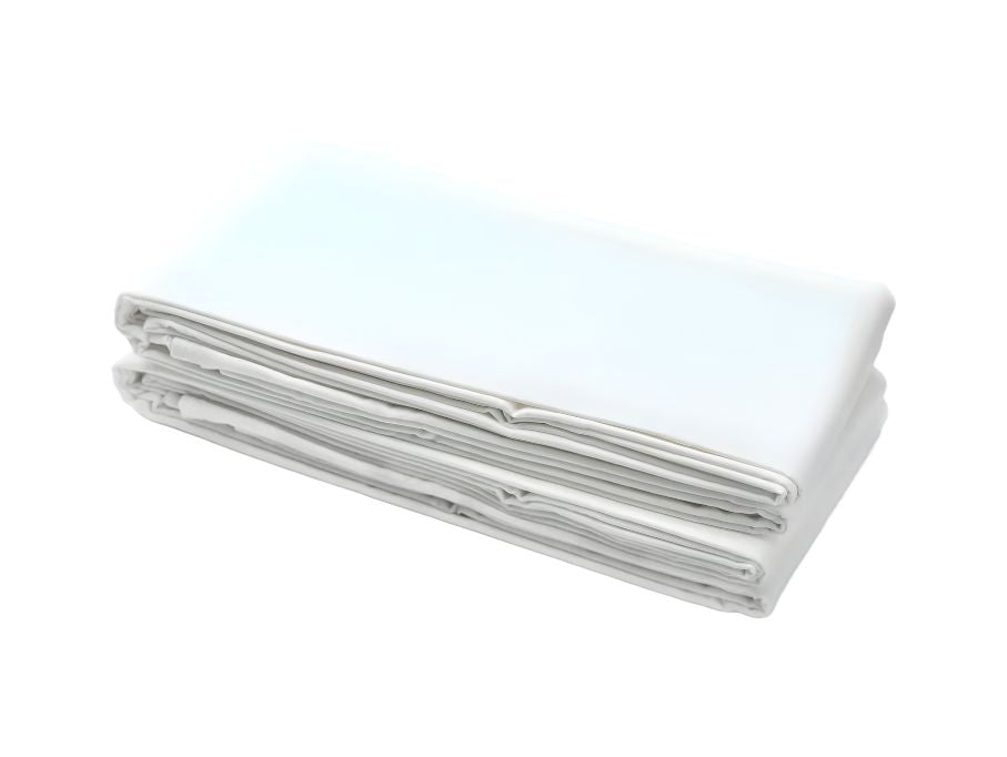 A neatly folded stack of The Linen Factory’s Duraknit Knitted Contour Sheets – Cotton/Polyblend (DZ) rests on a white background, highlighting their crisp, clean quality for professional use.