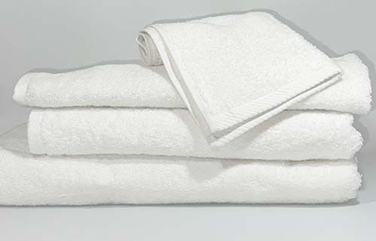 A neatly folded stack from Ganesh Mills’ Oxford Platinum Collection features three large white towels topped with a Washcloth - White Oxford Platinum Towel, all arranged on a flat surface against a plain, light background.