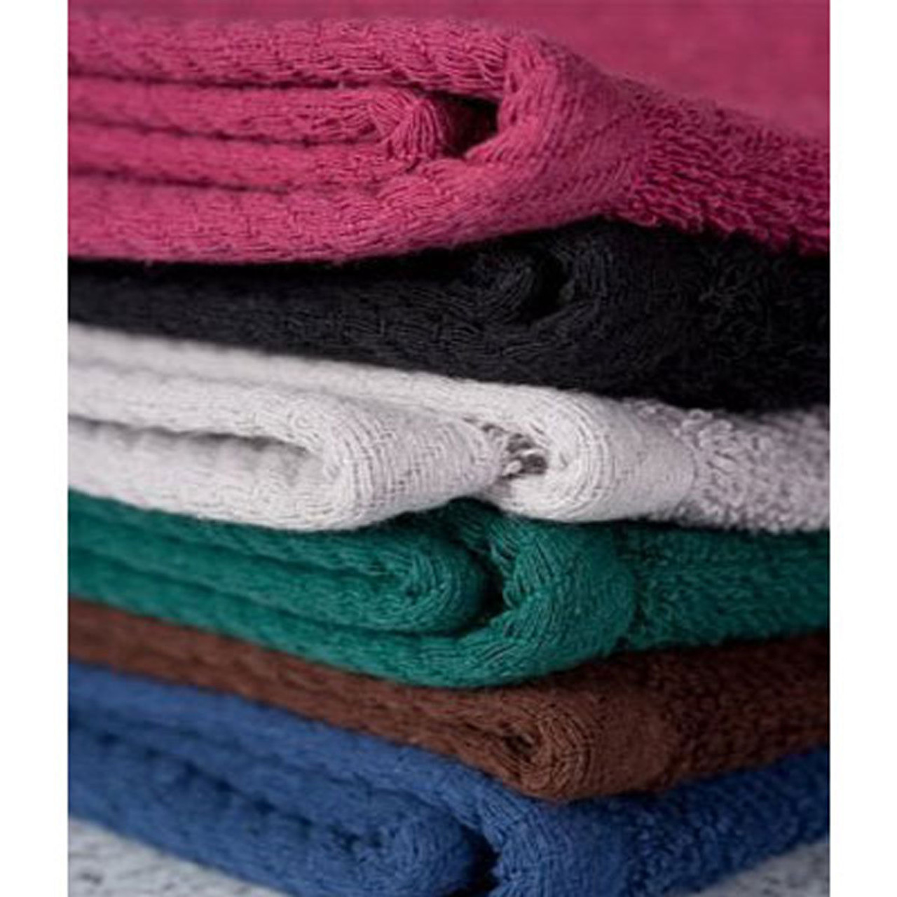 A close-up of seven Bleach Proof Oxford Salon and Spa Towels by Ganesh Mills, neatly folded in pink, black, gray, white, green, brown, and blue—ideal bulk towels for professional salon use.