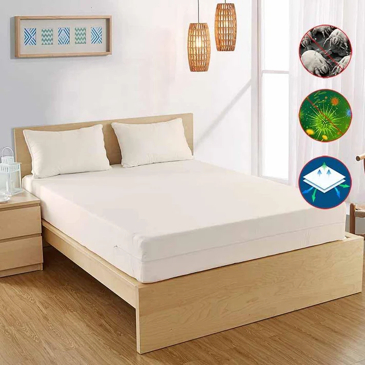 A bright bedroom with a neatly made bed features Bargoose AllergyCare™ Organic Cotton Zippered Mattress Encasement—18 deep—protecting against dust mites, bacteria, and water for a cleaner rest.