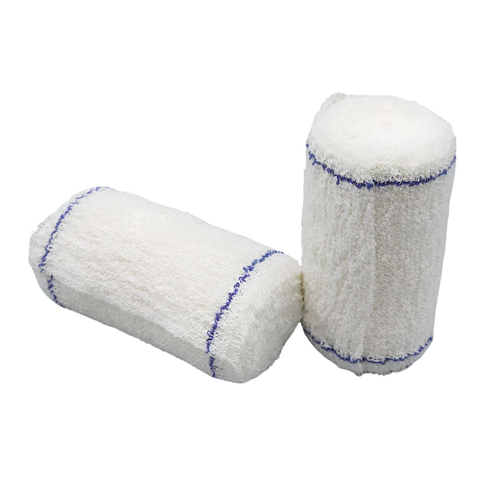 Two Shield Line Medpride Cotton Crepe Bandages (4M, assorted widths) are shown on a white surface—one horizontal, one upright—ideal for compression and injury support. Box includes 12 bandages in 2", 3", 4", and 6" sizes.