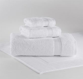 A plush white Emerald Wash Cloth by 1Concier, made from 100% cotton, is neatly folded and stacked on a white bath mat against a plain white background.