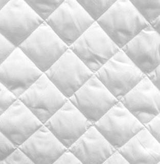 Close-up of the Mat Pad Super Basic Mattress Pad by 1Concier, featuring a white diamond-quilted pattern with 4-ounce fill. The soft, padded surface is designed for enhanced guest comfort.