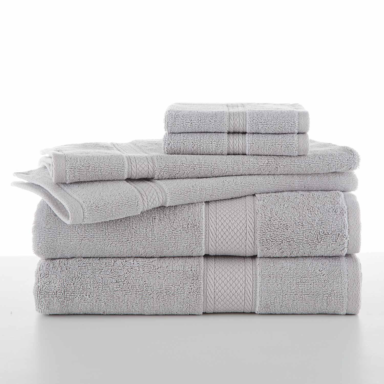 A neatly stacked set of WestPoint Home’s Grand Patrician Suites Dobby Towels in various sizes—bath towels, hand towels, and washcloths—rests on a white surface with a plain white background.