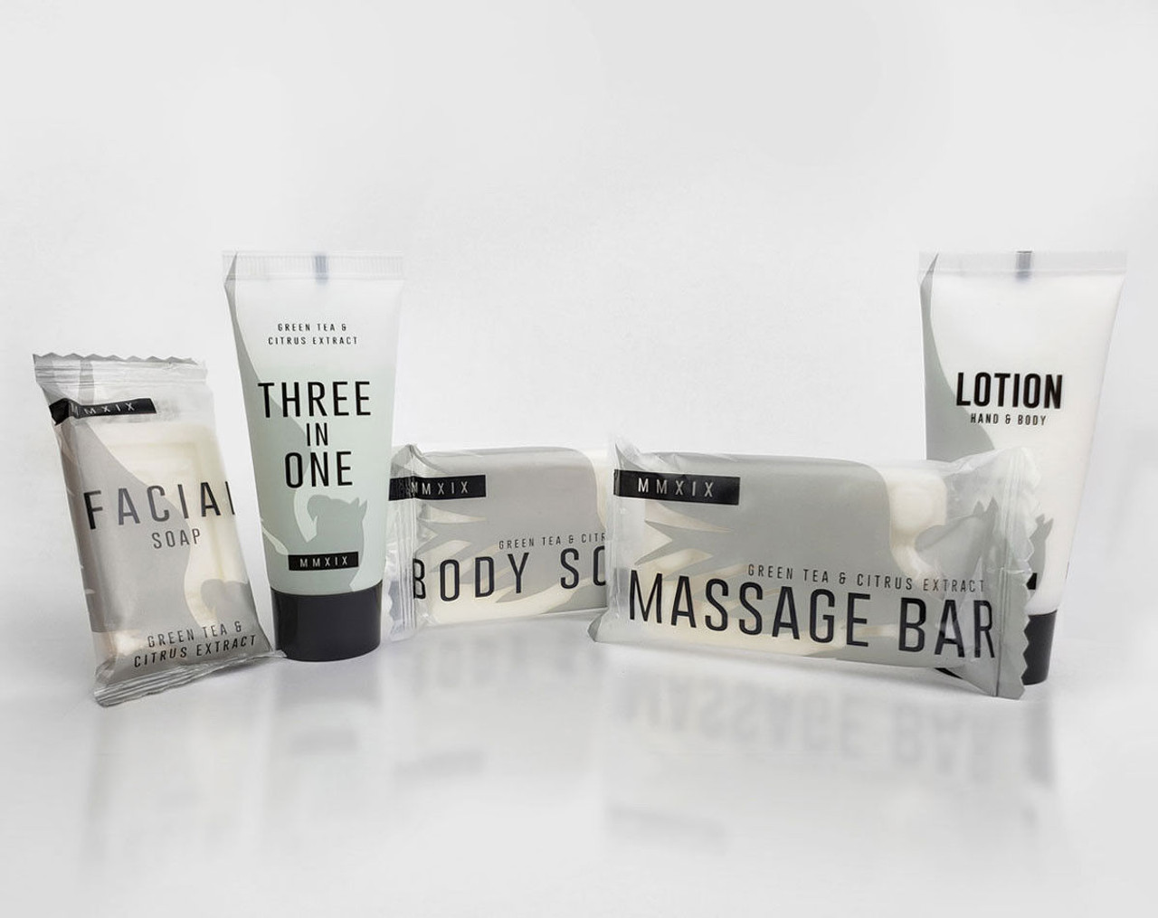A set of five premium Ganesh Mills hotel amenities, featuring Soap (Rectangle Shape) - Candy Wrap Embossed, all labeled with green tea & citrus extract—ideal as luxury body care products for hotels.