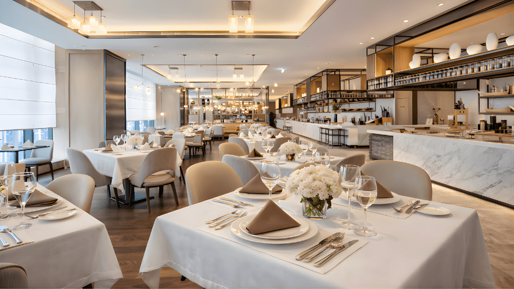 Restaurant dining room with white table linens and napkins for hospitality businesses