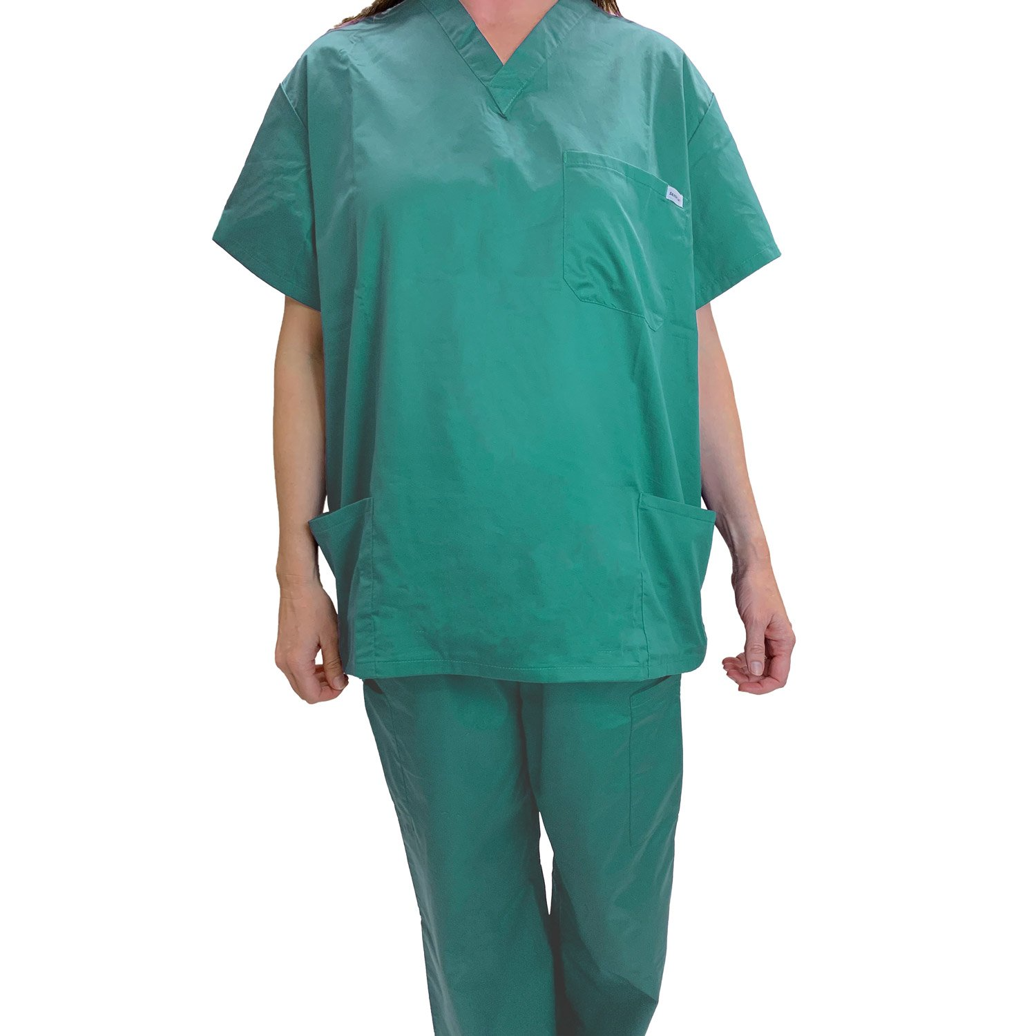 A person in WestPoint Home’s Martex Health Classic Scrub Top and matching pants stands against a white background. The short-sleeved V-neck top features pockets. The person’s head is not visible.