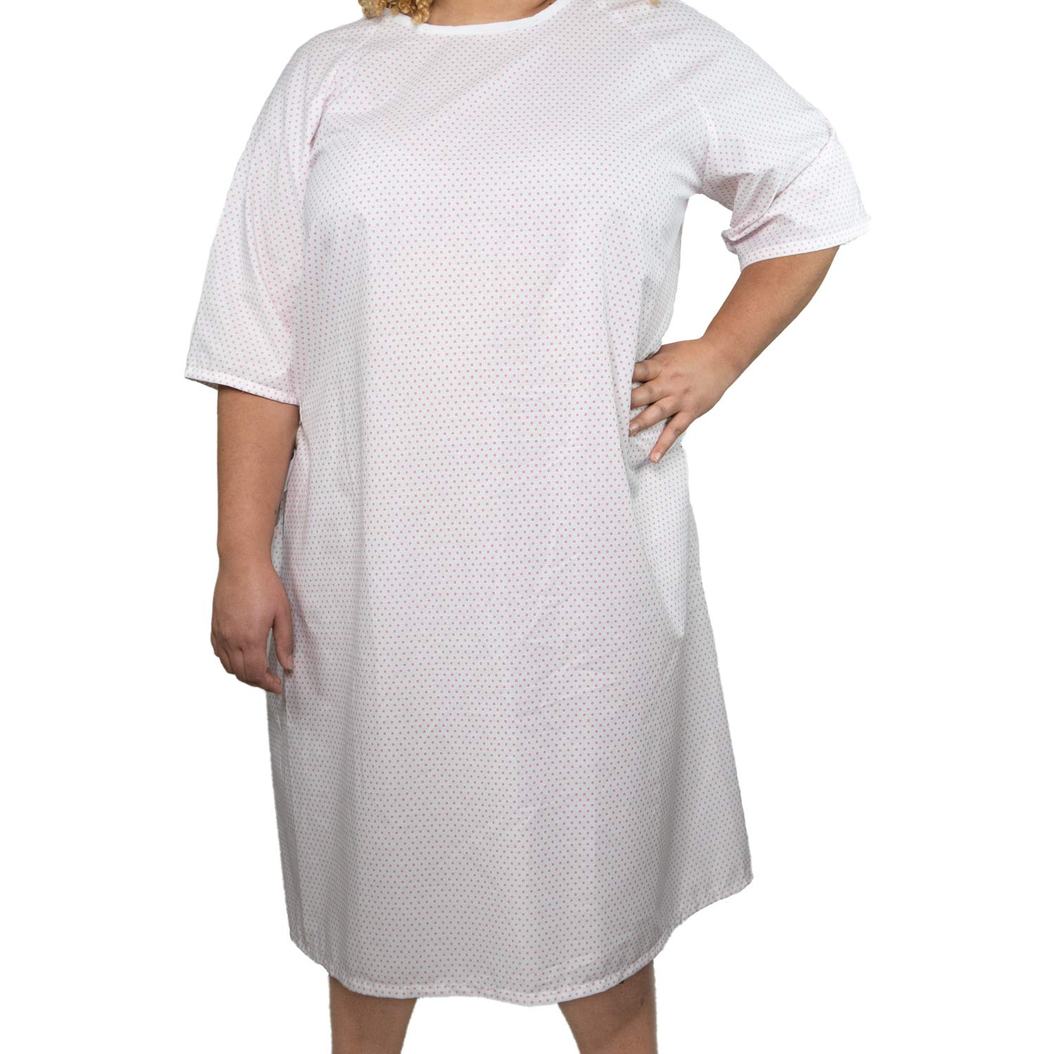A person wearing a loose-fitting, short-sleeved Martex Health Lab Coat by WestPoint Home, featuring SILVERbac antimicrobial technology and a subtle dotted pattern, stands with one hand on their hip against a plain white background.