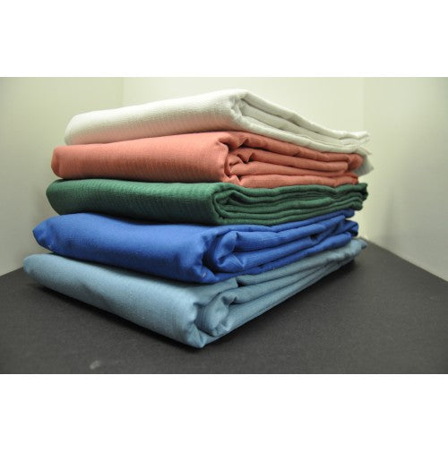 The Intralin Sheffield Snag Free Blankets, available in white, pink, green, blue, and light blue, are neatly stacked on a dark surface with a plain background—an elegant bedspread option for any room.