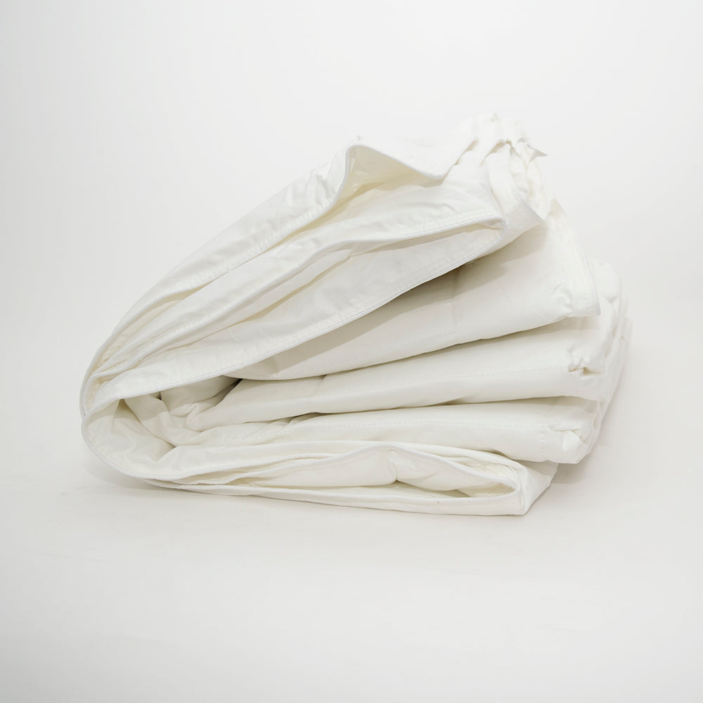 The Camelot Duvet Twin by Calderon Textiles is shown neatly folded on a white background, highlighting its lightweight, soft, crisp feel and easy care—machine washable for your convenience.