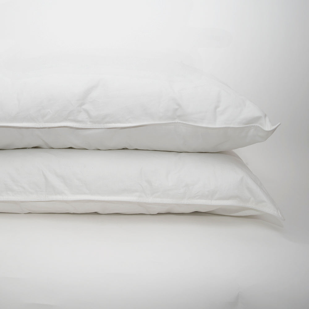 Two Sweet Dream Washable Pillows by Calderon Textiles, both white and hypoallergenic, stacked together against a plain white background.