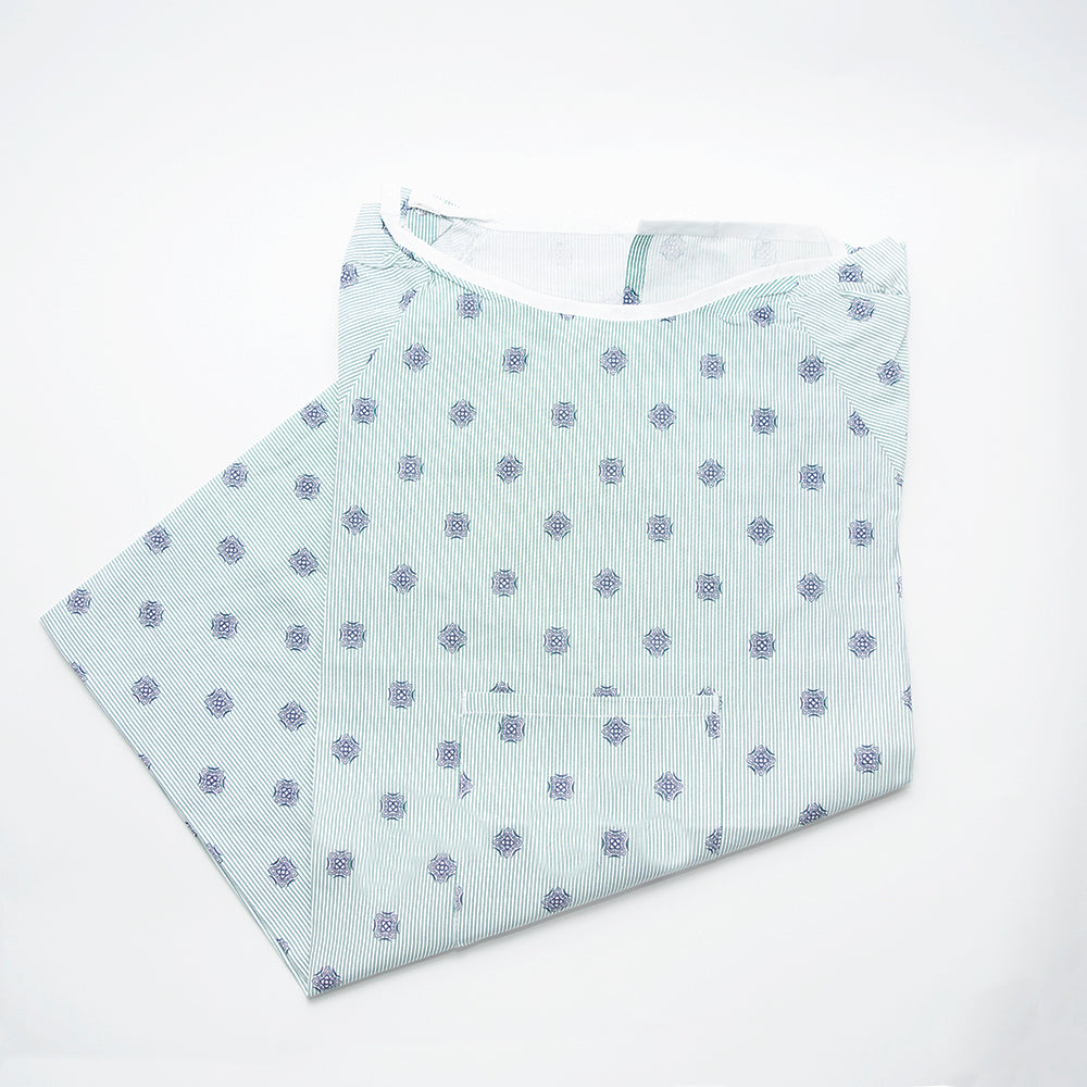The Calderon Textiles IV Twill Overlap and Pocket Patient Gown features light blue and white stripes with blue circular patterns, shown neatly folded on a white background.