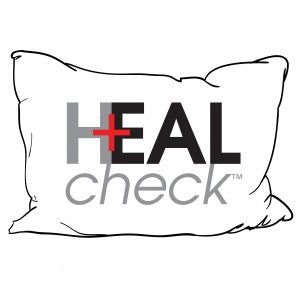 The KSE HealCheck™ Vinyl Pillow is a white critical care pillow featuring HEAL (H with a red medical cross as the bar) in black outline. Made from fluid-proof vinyl for durability and easy cleaning.