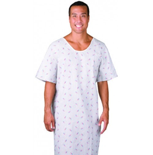 A smiling man wears the Intralin Gowns - Twill Patient Gown, featuring a subtle red and blue pattern on white. This short-sleeved, loose-fit hospital gown ensures comfort. The backdrop is plain white.