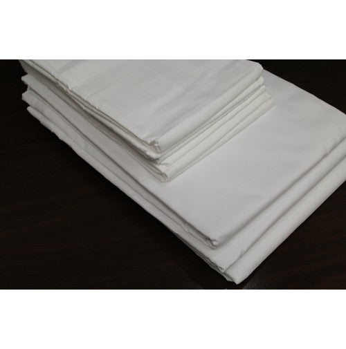 A neatly folded stack of Intralin T-128 Bargain Flat Sheets and pillow cases is placed on a dark surface.